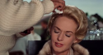 Movie still from “The Birds” (1963), directed by Alfred Hitchcock – A woman getting her hair combed by a stylist; Close Up shot, Over the shoulder angle