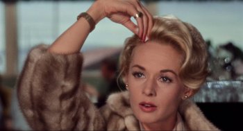 Movie still from “The Birds” (1963), directed by Alfred Hitchcock – A person touching her hair; Close Up shot, Low angle