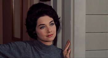 Movie still from “The Birds” (1963), directed by Alfred Hitchcock – A beautiful woman with blue eye shadow and red lipstick; Close Up shot, Low angle