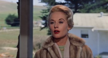 Movie still from “The Birds” (1963), directed by Alfred Hitchcock – A woman with blonde hair wearing a fur coat; Close Up shot, Low angle
