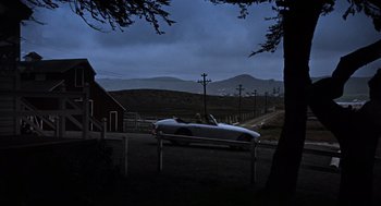 Movie still from “The Birds” (1963), directed by Alfred Hitchcock – A car parked in the middle of the night; Extreme Wide shot, High angle