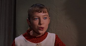 Movie still from “The Birds” (1963), directed by Alfred Hitchcock – A young girl with blue eyes is looking at the camera; Close Up shot, High angle