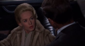 Movie still from “The Birds” (1963), directed by Alfred Hitchcock – A man and a woman are talking in the back of a car; Close Up shot, Over the shoulder angle