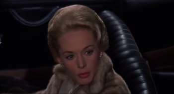 Movie still from “The Birds” (1963), directed by Alfred Hitchcock – A person wearing a fur coat; Close Up shot, High angle