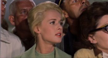 Movie still from “The Birds” (1963), directed by Alfred Hitchcock – A woman with blonde hair and a green sweater; Close Up shot, Low angle