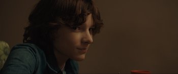 Movie still from “The Black Phone” (2021), directed by Scott Derrickson – A young boy is looking to his left; Close Up shot, Over the shoulder angle
