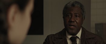 Movie still from “The Black Phone” (2021), directed by Scott Derrickson – An older black man wearing a brown jacket; Close Up shot, Over the shoulder angle