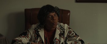 Movie still from “The Black Phone” (2021), directed by Scott Derrickson – An older woman sitting in a chair with her mouth wide open; Close Up shot, Low angle