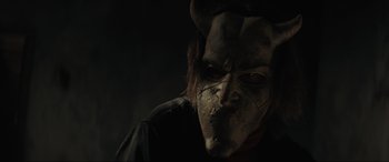 Movie still from “The Black Phone” (2021), directed by Scott Derrickson – A man with a demon mask on his face; Close Up shot, Low angle
