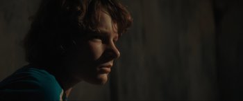 Movie still from “The Black Phone” (2021), directed by Scott Derrickson – A person's face in the dark; Close Up shot, Low angle