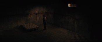 Movie still from “The Black Phone” (2021), directed by Scott Derrickson – A man standing in a dark room next to a bed; Extreme Wide shot, High angle