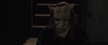 Movie still from “The Black Phone” (2021), directed by Scott Derrickson – A person with a demon mask on; Close Up shot, High angle