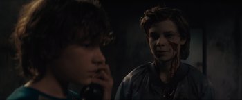 Movie still from “The Black Phone” (2021), directed by Scott Derrickson – Two young men standing next to each other in a dark room; Close Up shot, Over the shoulder angle