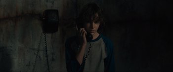 Movie still from “The Black Phone” (2021), directed by Scott Derrickson – A boy holding a phone up to his ear; Close Up shot, Over the shoulder angle