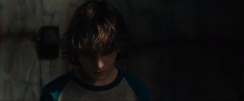 Movie still from “The Black Phone” (2021), directed by Scott Derrickson – A young boy is looking down at his face; Close Up shot, Over the shoulder angle