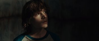 Movie still from “The Black Phone” (2021), directed by Scott Derrickson – A young boy is looking into the distance; Close Up shot, Low angle