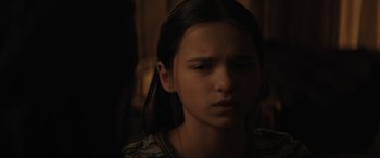Movie still from “The Black Phone” (2021), directed by Scott Derrickson – A young girl is looking at the camera; Close Up shot, Over the shoulder angle