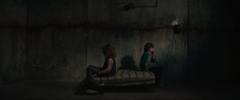 Movie still from “The Black Phone” (2021), directed by Scott Derrickson – A couple of people sitting next to each other on a bed; Wide shot, High angle