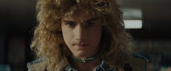 Movie still from “The Black Phone” (2021), directed by Scott Derrickson – A person wearing a necklace; Close Up shot, Over the shoulder angle