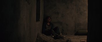 Movie still from “The Black Phone” (2021), directed by Scott Derrickson – A person sitting on the ground in a room; Medium shot, High angle