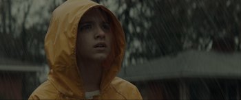 Movie still from “The Black Phone” (2021), directed by Scott Derrickson – A young person in a yellow raincoat in the rain; Close Up shot, Low angle