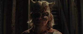 Movie still from “The Black Phone” (2021), directed by Scott Derrickson – A man with a demon mask on his face; Close Up shot, Low angle