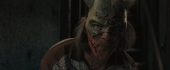 Movie still from “The Black Phone” (2021), directed by Scott Derrickson – A person with a mask and some blood on their face; Extreme Close Up shot, High angle