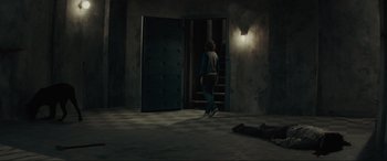 Movie still from “The Black Phone” (2021), directed by Scott Derrickson – A man is walking down the stairs of a house; Wide shot, High angle