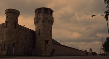 Movie still from “The Blues Brothers” (1980), directed by John Landis – A brick building with a green traffic light on top of it; Extreme Wide shot, Low angle