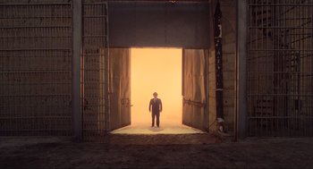 Movie still from “The Blues Brothers” (1980), directed by John Landis – A man standing in front of an opening in a building; Extreme Wide shot, High angle