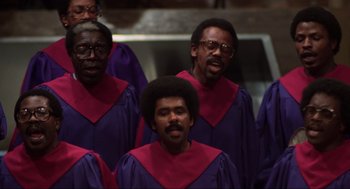 Movie still from “The Blues Brothers” (1980), directed by John Landis – A group of men standing next to each other wearing purple robes; Close Up shot, Low angle