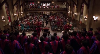 Movie still from “The Blues Brothers” (1980), directed by John Landis – A group of people sitting in front of an audience; Extreme Wide shot, High angle