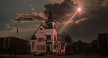 Movie still from “The Blues Brothers” (1980), directed by John Landis – A church with a steeple in the middle of a street; Extreme Wide shot, Low angle