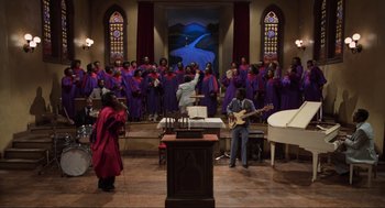 Movie still from “The Blues Brothers” (1980), directed by John Landis – A group of people standing in a room with instruments; Extreme Wide shot, High angle