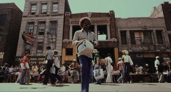Movie still from “The Blues Brothers” (1980), directed by John Landis – A group of people walking down a street; Wide shot, Low angle