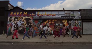 Movie still from “The Blues Brothers” (1980), directed by John Landis – A group of people walking down a street; Extreme Wide shot, Low angle