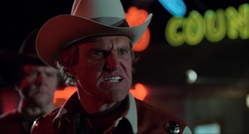 Movie still from “The Blues Brothers” (1980), directed by John Landis – A man in a white cowboy hat and a brown jacket; Close Up shot, Low angle