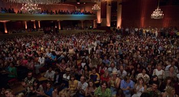 Movie still from “The Blues Brothers” (1980), directed by John Landis – A crowd of people sitting in a large auditorium; Extreme Wide shot, High angle