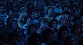 Movie still from “The Blues Brothers” (1980), directed by John Landis – A group of people sitting in a room; Medium shot, High angle