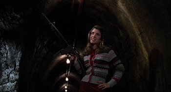 Movie still from “The Blues Brothers” (1980), directed by John Landis – A woman holding a rifle in a tunnel; Medium shot, Low angle