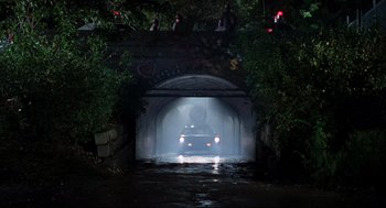 Movie still from “The Blues Brothers” (1980), directed by John Landis – A car is driving through a tunnel in the dark; Extreme Wide shot, Low angle