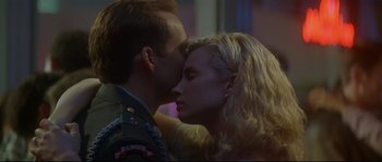 Movie still from “Con Air” (1997), directed by Simon West – A man and a woman are kissing in a room; Close Up shot, Low angle