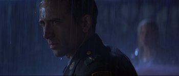 Movie still from “Con Air” (1997), directed by Simon West – A man in a military uniform standing in the rain; Close Up shot, Low angle