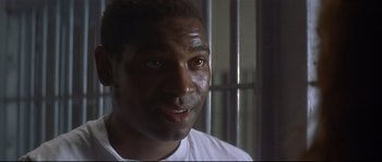 Movie still from “Con Air” (1997), directed by Simon West – A person in a jail cell; Close Up shot, Low angle