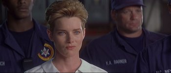 Movie still from “Con Air” (1997), directed by Simon West – A person wearing a white shirt; Close Up shot, Over the shoulder angle