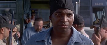 Movie still from “Con Air” (1997), directed by Simon West – A person wearing a hat; Close Up shot, Low angle