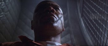 Movie still from “Con Air” (1997), directed by Simon West – A man's face looking upward; Close Up shot, Low angle