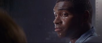 Movie still from “Con Air” (1997), directed by Simon West – A man's face covered in sweat; Close Up shot, Low angle