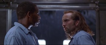 Movie still from “Con Air” (1997), directed by Simon West – Two men looking at each other in a room; Close Up shot, Low angle