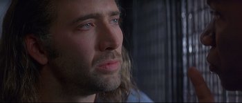 Movie still from “Con Air” (1997), directed by Simon West – A person with long hair; Close Up shot, Over the shoulder angle